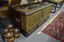 A good brass bound and studded Eastern coffer with turned feet.
