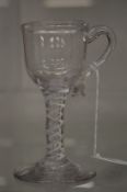 An 18th century wine glass with handle and air twist stem.