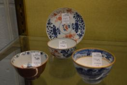 A Chinese blue and iron red tea bowl and saucer, small rim chips to both together with a Chinese