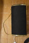 A black and gilt clutch bag.