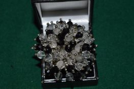 A silver ring set with crystals.