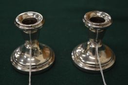A pair of silver dwarf candlesticks.