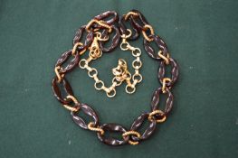 A decorative amber and gilt metal chain.