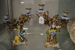 A good pair of Capodimonte porcelain figural twin light candelabra.