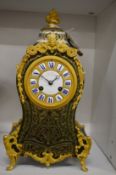 A 19th century boulle mantel clock with green stained tortoiseshell and ormolu mounts, the dial