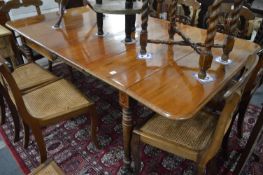 A 19th century mahogany extending dining table with drop-flap ends and a pair of leaves.