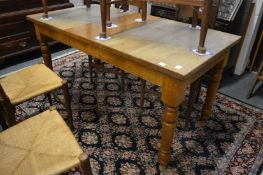 A small oak rectangular extending dining table with one leaf.