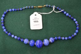 A veined blue stone bead necklace.