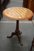 Victorian walnut tripod table with checker board inlaid top.