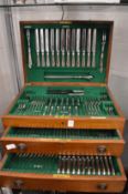 A mahogany cased part canteen of cutlery.
