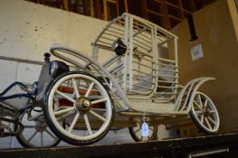 An unusual model of an early car.