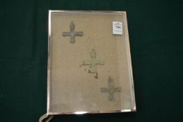 Three small bronze crucifixes framed and glazed.