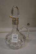 Cut glass oil bottle with silver mounts.