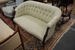 A small button upholstered Edwardian settee.