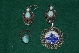 A silver and turquoise ring and pendant.