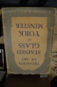 A book on the stained glass windows of York Minster together with a Bible and other books.
