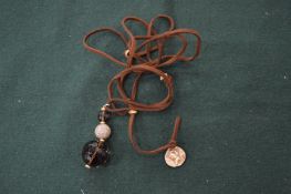 A bead and rope necklace.