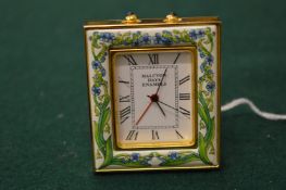 A Halcyon Days enamel miniature clock.