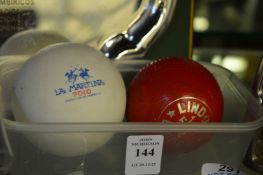 A polo ball and a practice cricket ball.