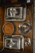 A pair of silver plated entree dishes and covers and other plated items.