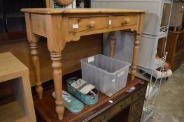 A pine two drawer side table.