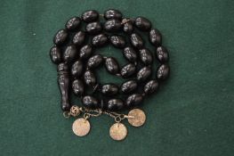An amber style necklace set with coins.