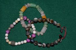 Three hard stone bracelets.