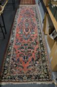 A Persian design runner, pink ground with floral decoration, 346cm x 97cm.