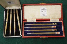 Two cased sets of bridge pencils.