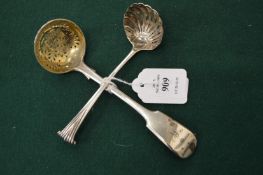 Two silver sifting spoons.