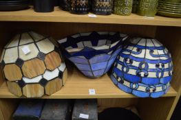 A collection of Art Nouveau style stained glass lamp shades.