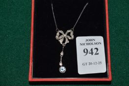 A silver, diamond and aquamarine pendant and chain.