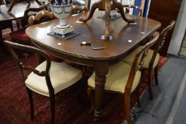 A late Victorian mahogany extending dining table on turned and reeded legs together with replacement