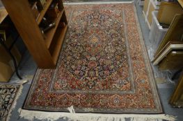 A Persian rug, blue ground with floral decoration, 215cm x 140cm.