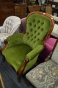 A Victorian mahogany framed button upholstered armchair.