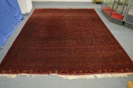 A Persian Bokhara carpet, 345cm x 255cm.