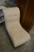 A small upholstered chair.