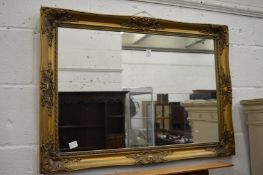A Victorian style gilt framed wall mirror.