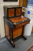 A 19th century burr wood, ebony and brass mounted Davenport, the upper section with two panelled
