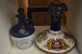 Two decorative rum decanters with contents.