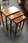 A satin wood banded mahogany nest of tables.
