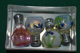 Four decorative miniature scent bottles.