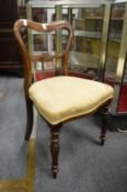 A set of four Victorian rosewood dining chairs.