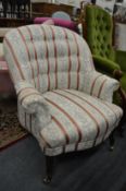 A Victorian style upholstered armchair.