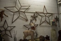 A collection of wrought iron star shaped ornaments, various sizes.