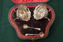 A pair of silver salts with spoons in associated case.