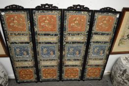 A good Chinese four panel screen, each panel with set of silk embroidered pictures.