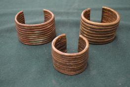 Three African brass bracelets.