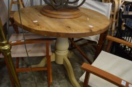 A pine and painted pine circular kitchen table.