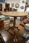 A mahogany circular tripod table.